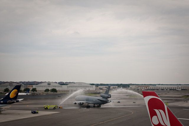 The firetrucks at JFK honor the departing plane.